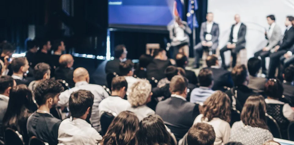 Audience watching a panel on stage