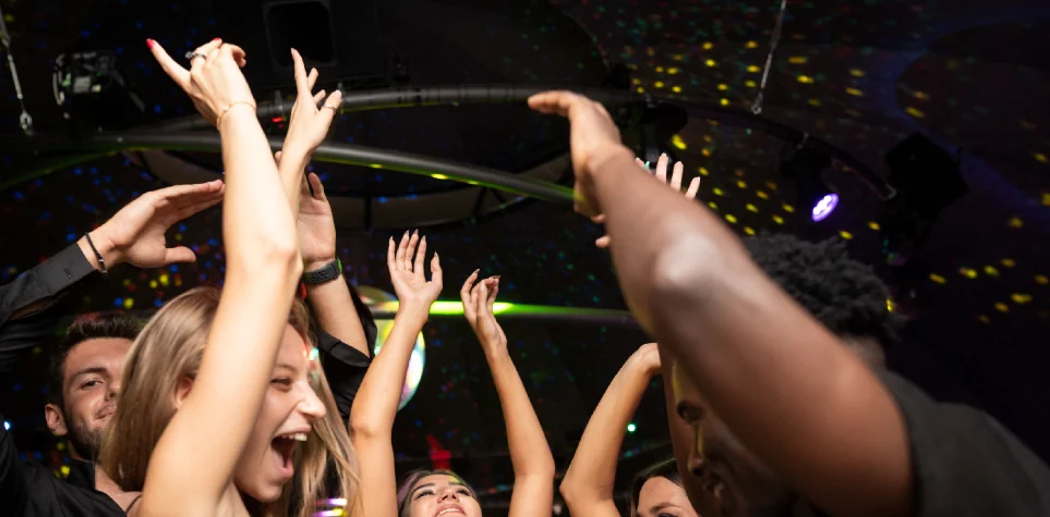 Guests dancing with their arms in the air