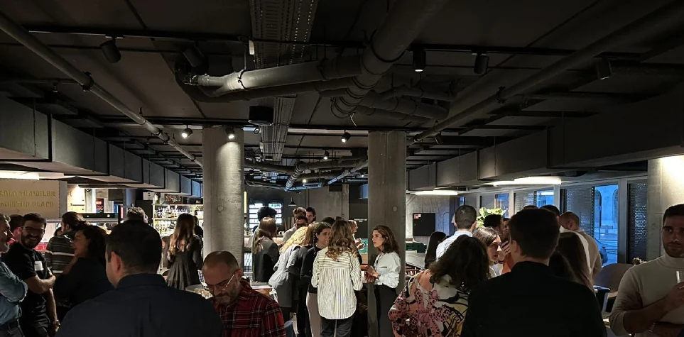 People networking in a large industrial-style hall